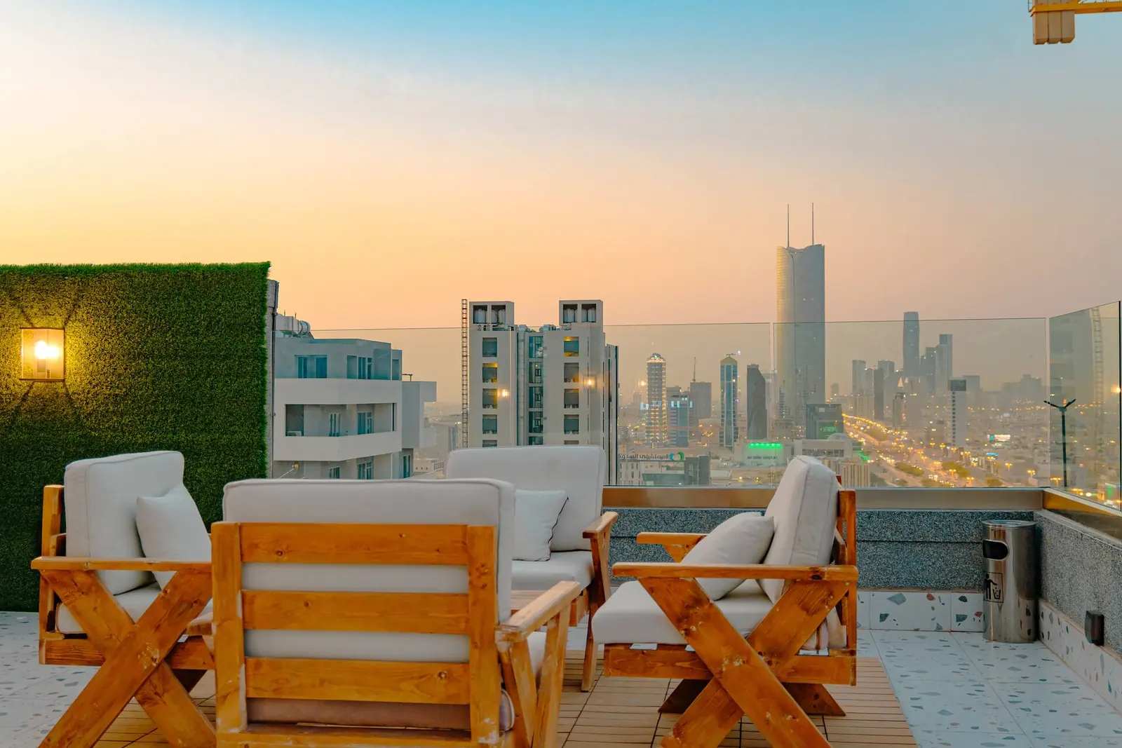 Rooftop lounge of the building at sunset, looking over the Riyadh skyline